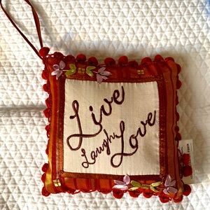 Small pillow for hanging on a door or cabinet.